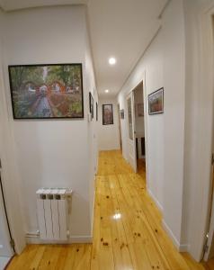 a hallway with white walls and wooden floors at Apartamento Saioa in Pamplona