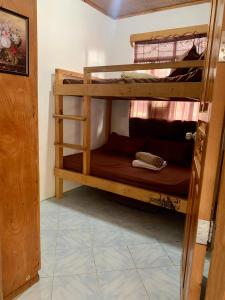 a couple of bunk beds in a room at K&GTransient House in Baguio