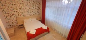 Postel nebo postele na pokoji v ubytování OITUZ Boutique Residence