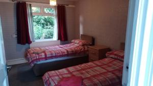 a room with two twin beds and a window at 21 Orion drive in Bristol