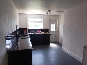 a kitchen with a black counter and a window at 21 Orion drive in Bristol