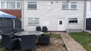 a patio with a table and chairs in front of a house at 21 Orion drive in Bristol