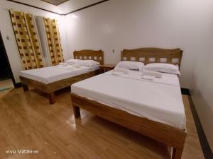 Postel nebo postele na pokoji v ubytování Rabang Traveller's Inn