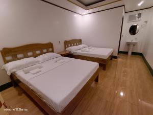 Postel nebo postele na pokoji v ubytování Rabang Traveller's Inn