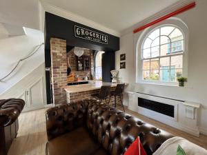 a living room with a couch and a fireplace at Riverside Mews - Yarm High Street in Yarm