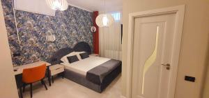 Postel nebo postele na pokoji v ubytování OITUZ Boutique Residence