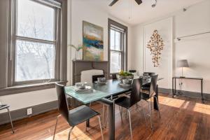 a dining room with a table and black chairs at Deluxe 5-bedroom Walk everywhere in Over the Rhine in Cincinnati
