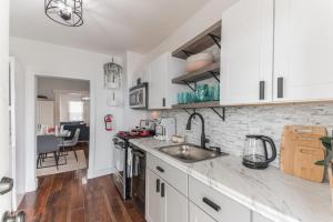 a kitchen with white cabinets and a counter top at Charming Home in AC Parking 5 min to Borgata in Atlantic City