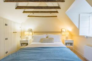 a bedroom with a blue bed with two night stands at Portobello Court in Kent