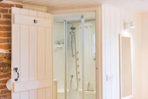 a bathroom with a shower with a glass door at Portobello Court in Kent
