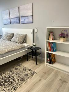 a bedroom with a bed and a book shelf at panoramic view and free parking in Vilnius