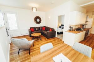 a living room with a couch and a table at Cottages in Derbyshire - Duffield Apartment in Duffield