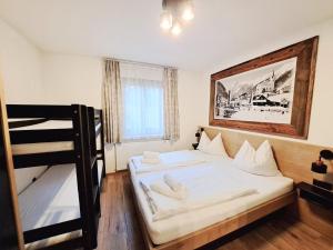 a bedroom with a bed and a bunk bed at Chalet Sabrina mit Außenpool im Sommer in Kaprun