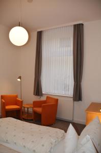 a hotel room with a bed and a window at Ferienhaus Pauls Ferienhaus Pauls, Whg 03 in Norderney +3 photos