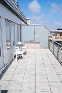 a patio with a table and chairs on a balcony at Alte Teestube Alte Teestube 14 in Norderney