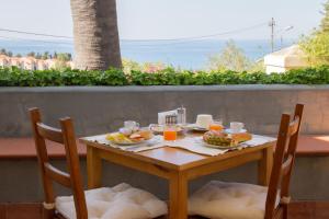 a table with a plate of food and drinks on it at Bouganville B&B in Cefalù
