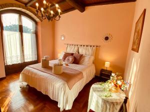 a bedroom with a large bed with two tables at La Rosa di Langa - Charming Panoramic House in Albaretto Della Torre 