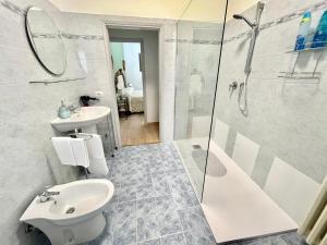 a bathroom with a sink and a toilet and a shower at Affittacamere Il Piccolo Borgo Foligno in Foligno