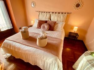 a bedroom with a large bed with two baskets on it at La Rosa di Langa - Charming Panoramic House in Albaretto Della Torre 