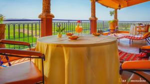 a table on a porch with a view of the ocean at Dar Amoudou in Ouarzazate