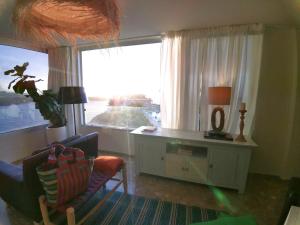 a living room with a desk and a window at Tenerife Stay Ocean Front I in San Marcos