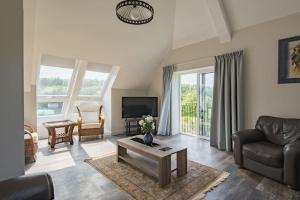 a living room with a couch and a tv at Reed Loft in Kingston