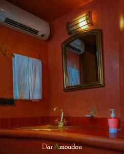 a bathroom with a sink and a mirror at Dar Amoudou in Ouarzazate