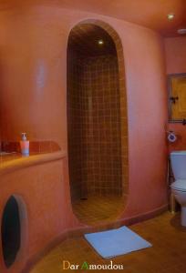a bathroom with a shower with a tub and a toilet at Dar Amoudou in Ouarzazate