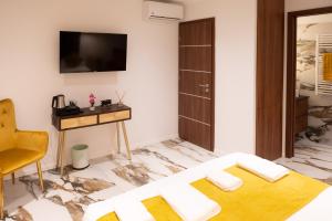 a living room with a couch and a tv on the wall at A CASA DI JO in Calenzana
