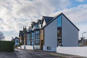 a house with a blue facade on a street at Sandy Villa in Westgate-on-Sea