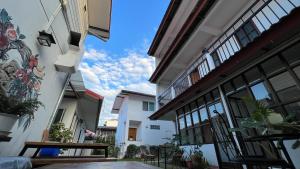 a view from the courtyard of a house with windows at Chiang Mai Gate house in Chiang Mai