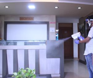 a person standing in a hospital lobby holding a wii controller at Hotel City Garden in Madgaon
