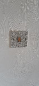 a lightswitch on the ceiling of a room at Our Guests Are Royal (EL) Wellingborough in Wellingborough