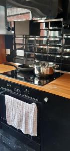 a kitchen with a stove with towels on the oven at Our Guests Are Royal (EL) Wellingborough in Wellingborough
