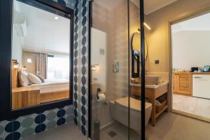 a bathroom with a shower and a sink and a bed at Ansira Fethiye in Fethiye