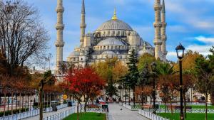 a view of theultanahmet mosque in istanbul with benches and trees at Hotel California in Istanbul