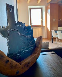 a large wooden chair sitting in a room at Da Mario Apartments in Malcesine