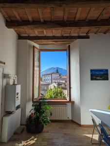 a kitchen with a window with a view of a city at Casa di Clara in Piazza, ideale per smartworking in Amandola