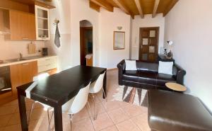 a living room with a black table and a couch at Da Mario Apartments in Malcesine