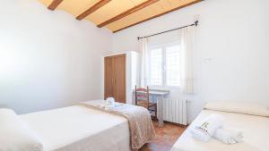 a bedroom with two beds and a window at Molino de Peralta Pozo Alcón by Ruralidays in Pozo Alcón +29 photos