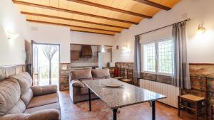 a living room with a couch and a table at Molino de Peralta Pozo Alcón by Ruralidays in Pozo Alcón