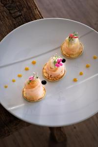 three pastries on a white plate on a table at Thalazur Arcachon in Arcachon