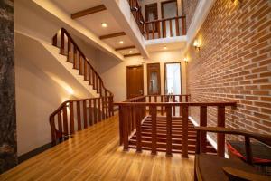 a room with stairs and a brick wall at The Land Hotel & Apartment in Vung Tau