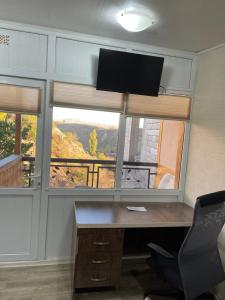 an office with a desk and a large window at Holiday House in Yerevan with Garden and Lovely Views in Yerevan