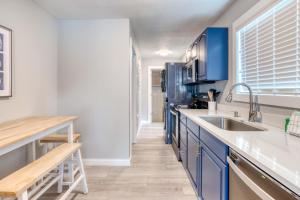 a kitchen with blue cabinets and a sink at On The Rocks in Rockaway Beach