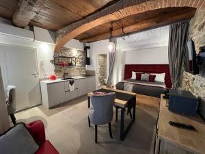 a bedroom with a bed and a desk and a table at Nobilia Dimore - Suite & Spa Privata in Stia
