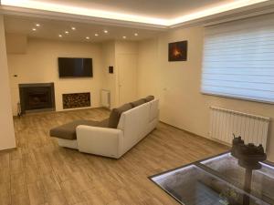 a living room with a couch and a fireplace at Etna holiday in Zafferana Etnea