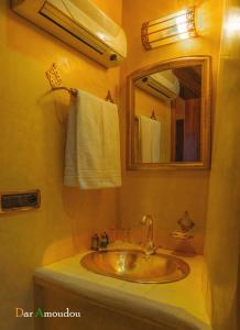 a bathroom with a sink and a mirror at Dar Amoudou in Ouarzazate