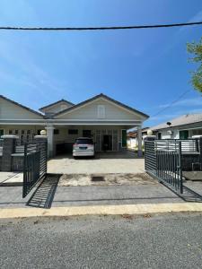 a house with a car parked in the driveway at Family Holiday Home With Wifi & Netflix in Sungai Petani