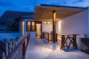 a deck of a house with a wooden roof at The Lagoon Canggu in Canggu